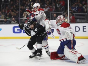 Carey Price and Brett Kulak  of the Montreal Canadiens defend as Adrian Kempe of the Los Angeles Kings dodges a shot on goal during the second period of a game at the Staples Center on March 5, 2019 in Los Angeles.