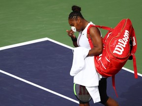 Serena Williams of the United States walks off court after retiring from her match in at the start of the second set against Garbine Muguruza of Spain during their women's singles third round match on day seven of the BNP Paribas Open at the Indian Wells Tennis Garden on March 10, 2019 in Indian Wells, Calif. (Clive Brunskill/Getty Images)