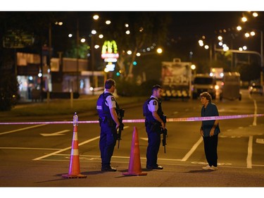 Police speak to a resident as they cordon off Linwood Ave. near the Linwood Masjid on March 15, 2019 in Christchurch, New Zealand.