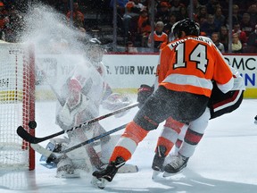 Senators' Craig Anderson looks back at the puck as it hits off of the goal post on a shot by Flyers' Sean Couturier during Monday's game. (GETTY IMAGES)