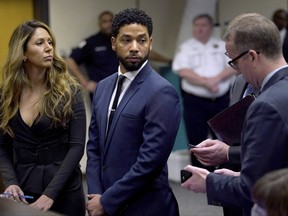 This March 14, 2019 file photo, actor Jussie Smollet, centre, looks at attorney Ron Safer as he stands with his lead attorney Tina Glandian in Cook County Circuit Court in Chicago. (E. Jason Wambsgans/ Chicago Tribune via AP, Pool)
