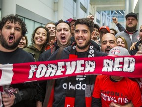 New TFC midfielder Alejandro Pozuelo poses with chanting fans after arriving at Toronto Pearson International Airport on Friday.