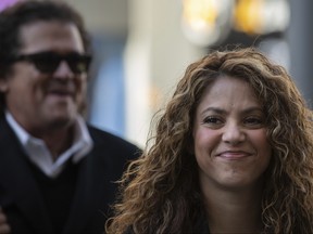 Colombian singers Shakira, right, and Carlos Vives, background, arrive at court in Madrid, Spain, Wednesday, March 27, 2019. (AP Photo)