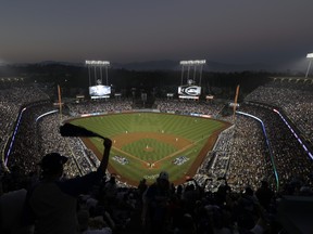 In this Oct. 27, 2018, file photo, fans cheer from the top of Dodger Stadium during Game 4 of the World Series baseball game between the Boston Red Sox and Los Angeles Dodgers in Los Angeles. (AP Photo/Elise Amendola, File)