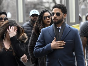 Empire actor Jussie Smollett, centre, arrives at the Leighton Criminal Court Building for his hearing on Thursday, March 14, 2019, in Chicago. (AP Photo/Matt Marton)