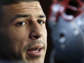 In this Sept. 5, 2012 file photo, New England Patriots tight end Aaron Hernandez speaks in the locker room at Gillette Stadium in Foxborough, Mass.
