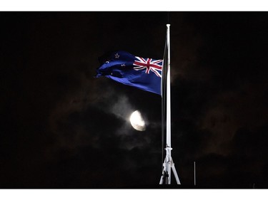 The New Zealand national flag is flown at half-mast on a Parliament building in Wellington on March 15, 2019, after a shooting incident in Christchurch.