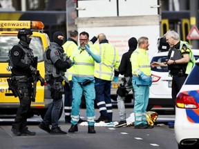 Police forces and emergency services stand at the 24 Oktoberplace in Utrecht, on Monday, March 18, 2019 where a shooting took place.