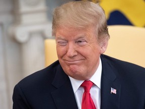 U.S. President Donald Trump winks during a meeting with Israeli Prime Minister Benjamin Netanyahu in the Oval Office at the White House in Washington, DC, March 25, 2019. (SAUL LOEB/AFP/Getty Images)