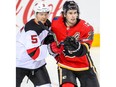 New Jersey Devils Connor Carrick battles Sean Monahan of the Calgary Flames during NHL hockey at the Scotiabank Saddledome in Calgary on Tuesday, March 12, 2019. Al Charest/Postmedia