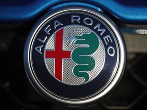In this Sunday, Jan. 7, 2018, file photograph, the company logo shines on the grille of an unsold 2018 Stelvio at an Alfa Romeo dealership in Highlands Ranch, Colo.