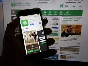 This photo shows the Absher App on a phone in Jiddah, Saudi Arabia, Thursday, March 7, 2019.