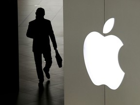 In this Jan. 3, 2019, file photo a man leaves an Apple store in Beijing.