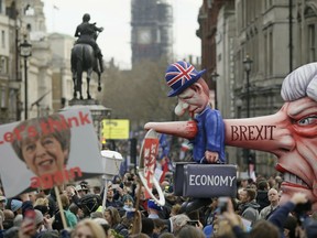 An effigy of British Prime Minister Theresa May is wheeled through Trafalgar Square during a Peoples Vote anti-Brexit march in London, Saturday, March 23, 2019.