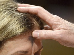 Rev. Joe Dunagan applies ashes to the foreheads of parishioner during an Ash Wednesday service at Emmanuel Episcopal Church Wednesday, March 6, 2019, in Bristol, Va. (David Crigger/Bristol Herald Courier via AP)