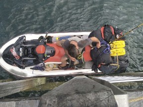 This photo released by the Australian Border Force, Wednesday, March 27, 2019, shows a wanted British man who was apprehended in the Torres Strait attempting to flee Australia on a personal watercraft. Australian police say the 57-year-old set out on Monday from the northern tip of Australia's Queensland state, carrying enough fuel to make the 140-kilometer (86-mile) trip across Torres Strait. The photo was manipulated to blur the watercraft's registration numbers. (Australian Border Force via AP)