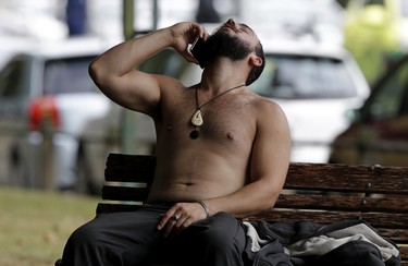 A man reacts as he speaks on a mobile phone outside a mosque in central Christchurch, New Zealand, Friday, March 15, 2019.