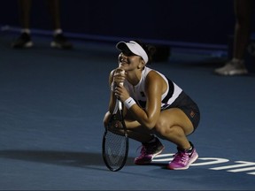 Canada's Bianca Andreescu squats on the court during her Mexican Tennis Open semifinal match against Sofia Kenin of the U.S., in Acapulco, Mexico, Friday, March 1, 2019.