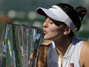 Canadian Bianca Andreescu kisses her trophy after defeating Angelique Kerber in the women's final at the BNP Paribas Open tennis tournament on Sunday.