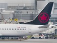 An Air Canada Boeing 737 Max 8 aircraft is shown next to a gate at Trudeau Airport in Montreal, Wednesday, March 13, 2019.