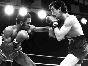 In this June 9, 1985 file photo, defending champion Eusebio Pedroza from Panama, left, throws a punch at Northern Ireland's Barry McGuigan, during their World Featherweight Championship fight at Queen's Park Rangers Football Ground, London.