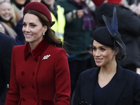 FILE - In this Tuesday, Dec. 25, 2018 file photo, Britain's Kate, Duchess of Cambridge, left, and Meghan, Duchess of Sussex arrive to attend the Christmas day service at St Mary Magdalene Church in Sandringham in Norfolk, England. Britain's royal family is warning that it will block trolls posting offensive messages on its social media channels _ and may report offenders to the police. Buckingham Palace, Clarence House and Kensington Palace issued new guidelines on Monday, March 4, 2019 spelling out the policy banning offensive, hateful and racist language.(AP Photo/Frank Augstein, File) ORG XMIT: AMB107