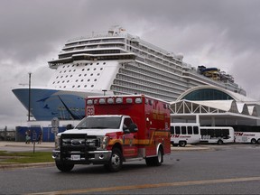An ambulance takes a patient from the cruise ship Norwegian Escape to a local hospital Sunday, March 3, 2019 in Port Canaveral, Fla. (Malcolm Denemark/Florida Today via AP)