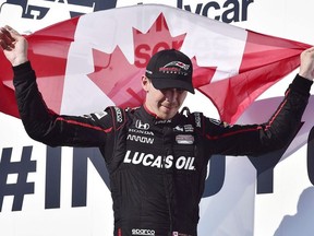 Robert Wickens celebrates his third place finish at the Honda Indy in Toronto on Sunday, July 15, 2018. Wickens says he will be in a race car again, saying it's "all I know."