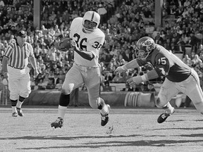In this Oct. 31, 1965, file photo, Clem Daniels of the Oakland Raiders races around the right side of his line as Jerry Mays, right, of the Kansas City Chiefs moves in for the tackle, in Kansas City, Mo.