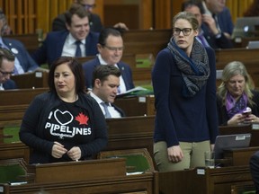 Conservative MPs Shannon Stubbs and Rachel Harder rise to cast their vote during a marathon voting session in the House of Commons Thursday March 21, 2019 in Ottawa. The Parliamentary session began Wednesday and continued through until Thursday as members voted. THE CANADIAN PRESS/Adrian Wyld