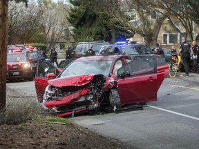 Police work the scene where two cars collided in Seattle, Wednesday, March 27, 2019, after a gunman opened fire on vehicles.