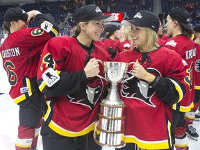 Calgary Inferno's Zoe Hickel (left) and Tori Hickel celebrate with the trophy after beating Les Canadiennes de Montreal 5-2 to win the 2019 Clarkson Cup game in Toronto, on Sunday, March 24 , 2019. (THE CANADIAN PRESS/Chris Young)