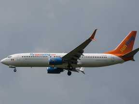 A Sunwing Boeing 737-800 passenger plane prepares to land at Pearson International Airport in Toronto on Wednesday, August 2, 2017. (THE CANADIAN PRESS/Christopher Katsarov)