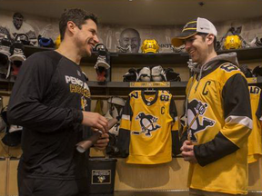 Penguins star Sidney Crosby (left) and Humboldt Broncos bus crash survivor Layne Matechuk pose for a photo in the team’s dressing room at PPG Paints Arena in Pittsburgh yesterday. Matechuk, whose hockey hero is Crosby, was invited to take in the Penguins-Capitals game Tuesday night. Liam Richards/Postmedia Network