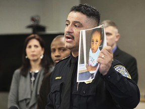 In this Friday, March 15, 2019, photo, Milwaukee Police Chief Alfonso Morales holds a photo of 2-year-old Noelani Robinson as he speaks at a news conference at the Police Administration Building in Milwaukee. (Michael Sears/Milwaukee Journal-Sentinel via AP)