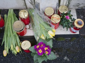 Flowers are set at a house of a doctor, who died in an explosion by a booby trap in Enkenbach-Alsenborn, Germany, Tuesday, March 5, 2019.