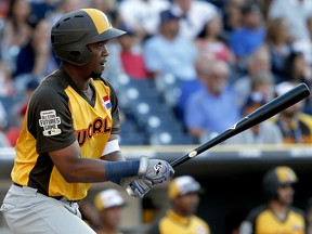In this July 10, 2016, file photo, World Team's Eloy Jimenez hits against the U.S. Team during the All-Star Futures game in San Diego. (AP Photo/Lenny Ignelzi, File)