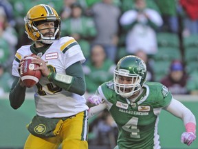 Saskatchewan Roughriders linebacker Cameron Judge gains on Edmonton Eskimos quarterback Mike Reilly in an October 2018 game. The CFL will consider another rule change to further protect the QBs.