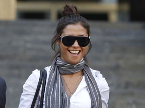 In this Monday, Oct. 3, 2011 file photo, Imane Fadil smiles as she leaves the court in Milan, Italy.
