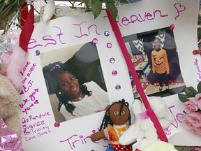 Photos adorn a large memorial to Trinity Love Jones, the nine-year-old girl whose body was found in a duffel bag along a suburban Los Angeles equestrian trail, in Hacienda Heights, Calif., Monday, March 11, 2019.