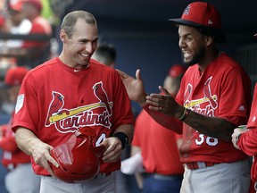 St. Louis Cardinals' Paul Goldschmidt, left, laughs with Jose Martinez in the dugout during a spring training game against the Washington Nationals Tuesday, Feb. 26, 2019, in West Palm Beach, Fla. (AP Photo/Jeff Roberson)