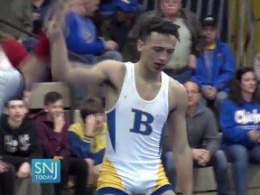In this Wednesday, Dec. 19, 2018 image made from video provided by SNJTODAY.COM, Buena Regional High School wrestler Andrew Johnson is declared the winner by referee Alan Maloney after a match in in Buena, N.J.