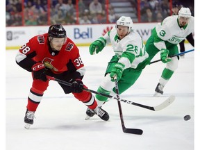 Ottawa Senators left wing Rudolfs Balcers battles Toronto Maple Leafs right wing Connor Brown during second period NHL hockey action in Ottawa on Saturday, March 16, 2019.