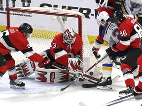 Ottawa Senators goaltender Anders Nilsson (31), defenceman Cody Ceci (5) and defenceman Christian Wolanin (86) try to control the puck against St. Louis Blues left wing Alexander Steen (20) during the first period at the CTC on Thursday March 14, 2019.