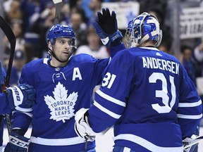 Toronto Maple Leafs centre John Tavares and goaltender Frederik Andersen celebrate their win over the Florida Panthers during NHL action in Toronto on Monday, March 25, 2019. =