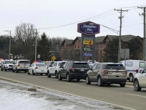 Area law enforcement vehicles gather near the scene of a shooting in Rockford, Ill., Thursday, March 7, 2019. (Ken DeCoster/Rockford Register Star via AP)
