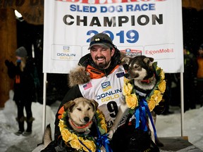 Peter Kaiser poses with his lead dogs, Morrow, left, and Lucy., Wednesday, March 13, 2019, in Nome, Alaska, after winning the Iditarod Trail Sled Dog Race.