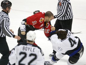 Calgary Flames Jarome Iginla wrestles Tampa Bay Lightning's Vincent Lecavalier to the ground in the first period of NHL playoff action at the Saddledome on May 29, 2004.