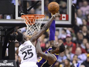 Raptors’ Chris Boucher blocks a shot from Los Angeles Lakers’ LeBron James on Thursday night in Toronto. (FRANK GUNN/THE CANADIAN PRESS)