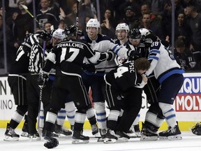 Players from the Jets and Kings get into a scuffle during the second period in Los Angeles last night.  Marcio Jose Sanchez/AP